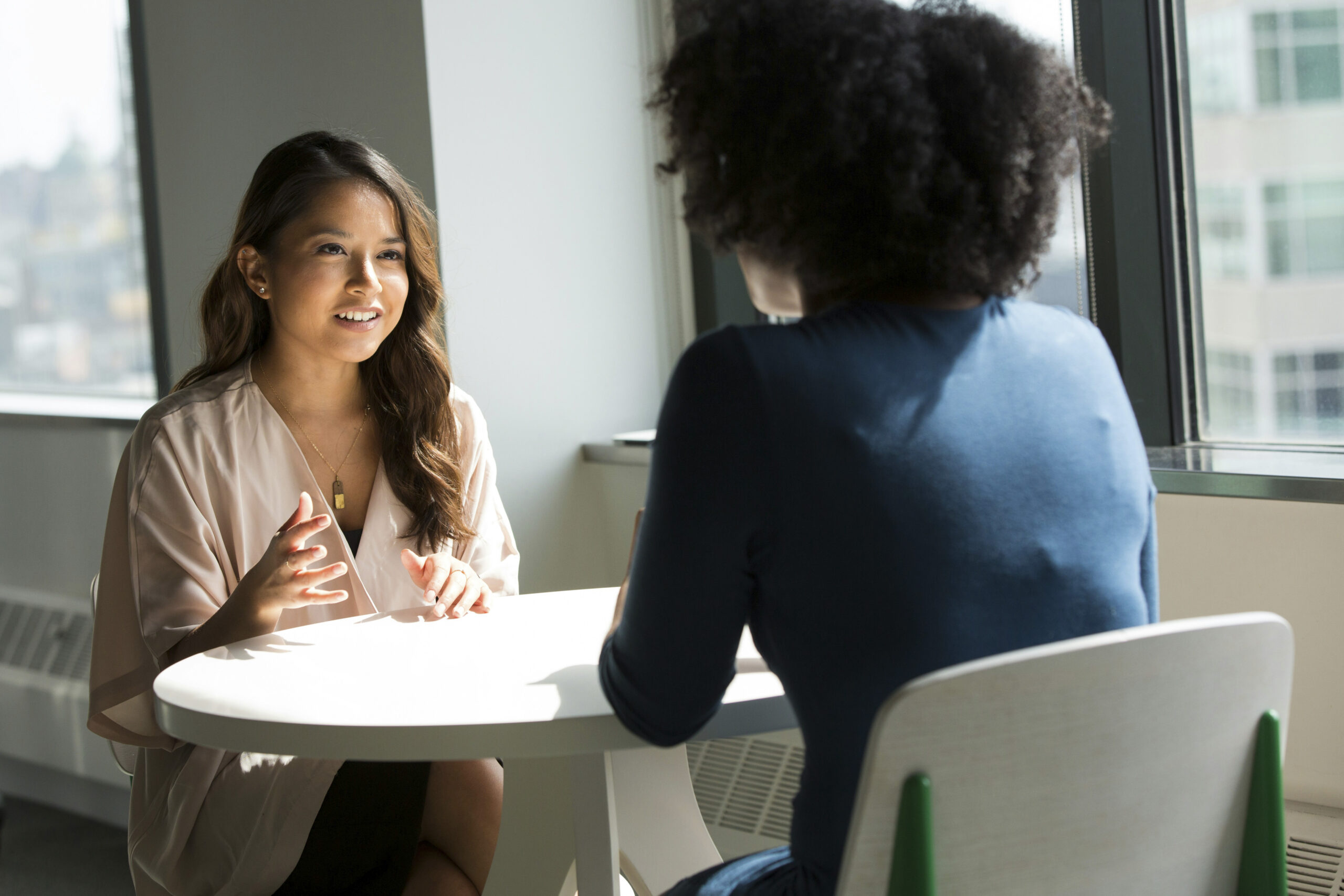 Two people talking together at a table